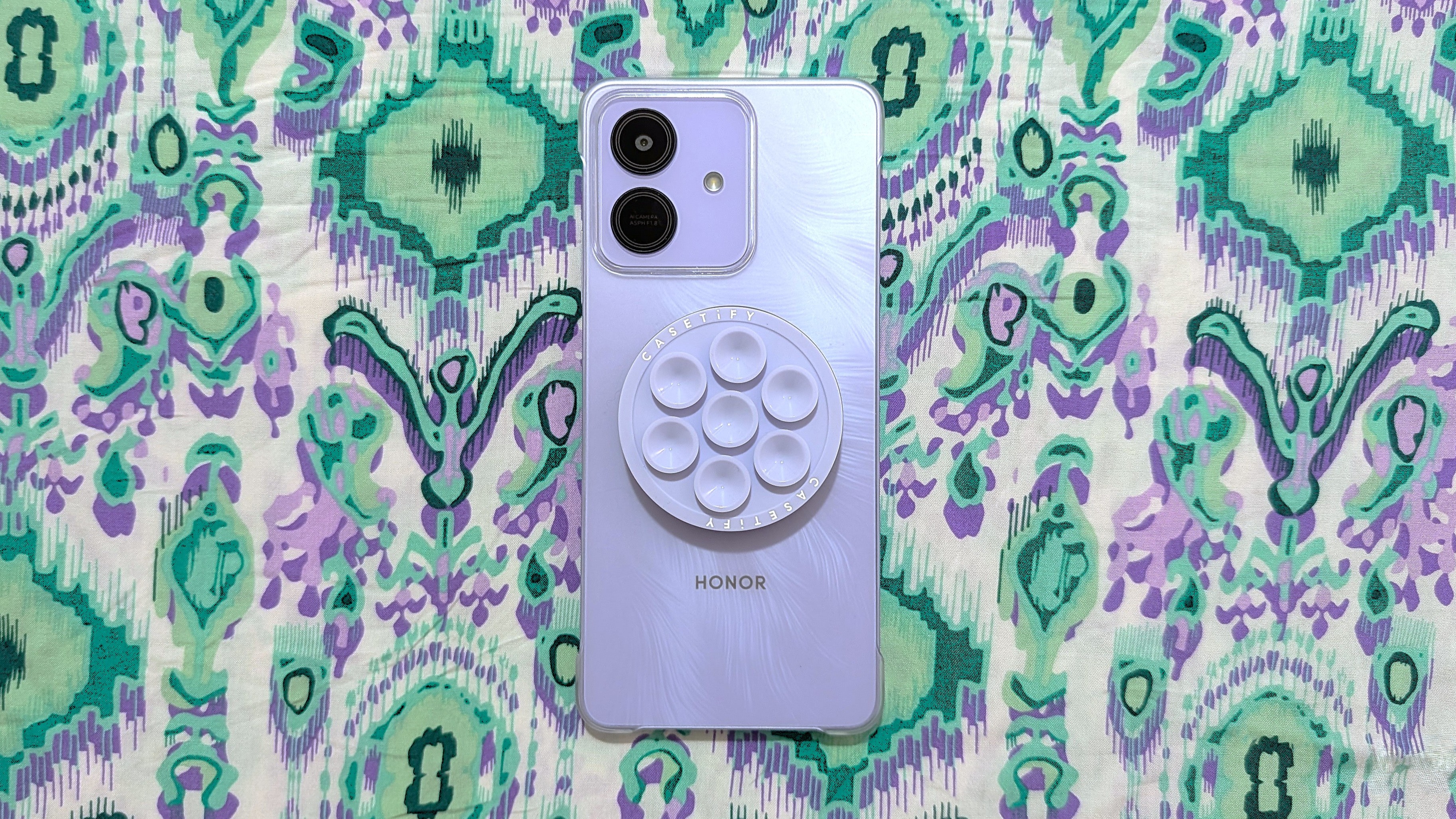 Honor Play 10 with clear case, magnetic ring sticker, and MagSafe accessories.