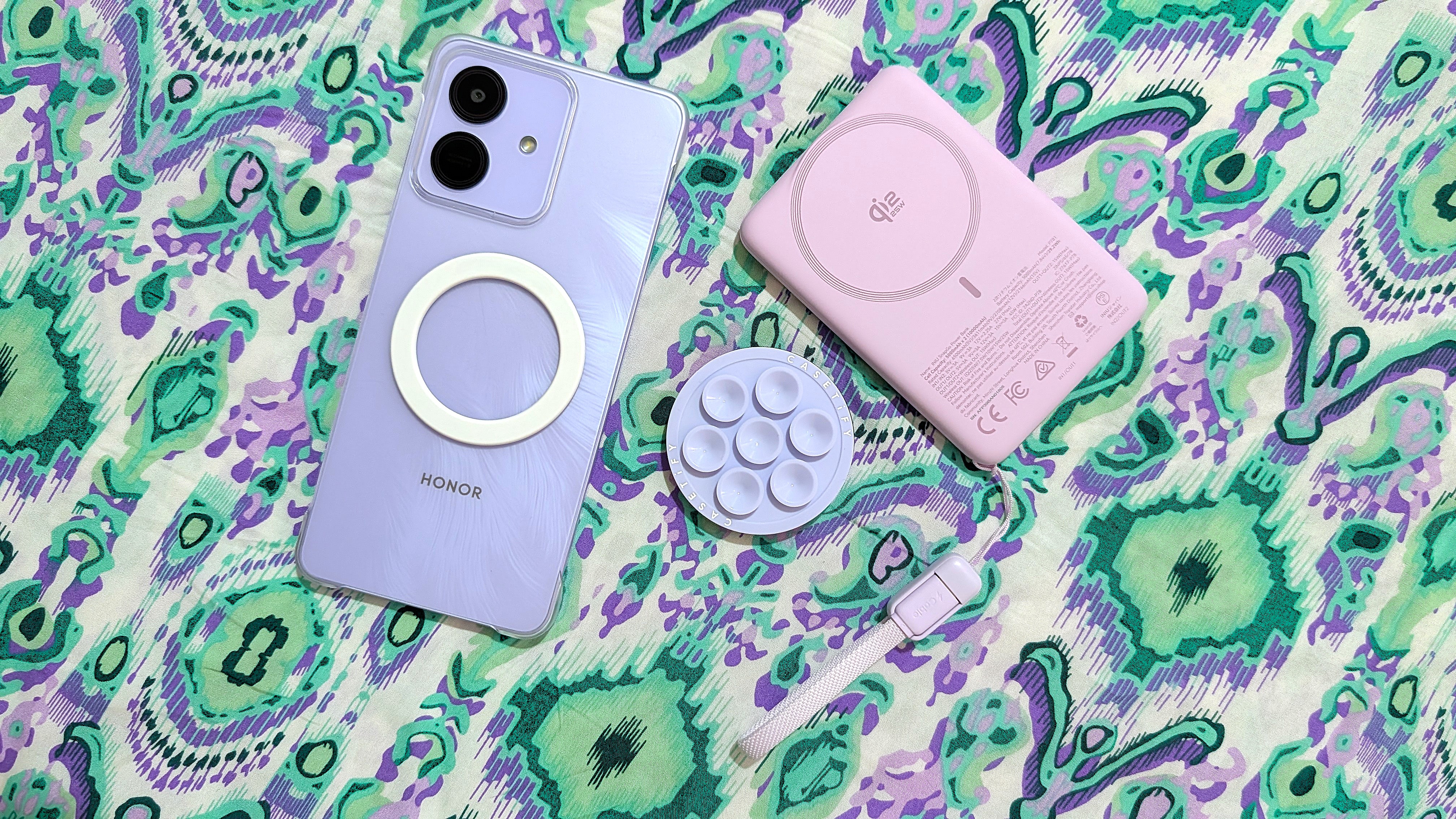 Honor Play 10 with clear case, magnetic ring sticker, and MagSafe accessories.