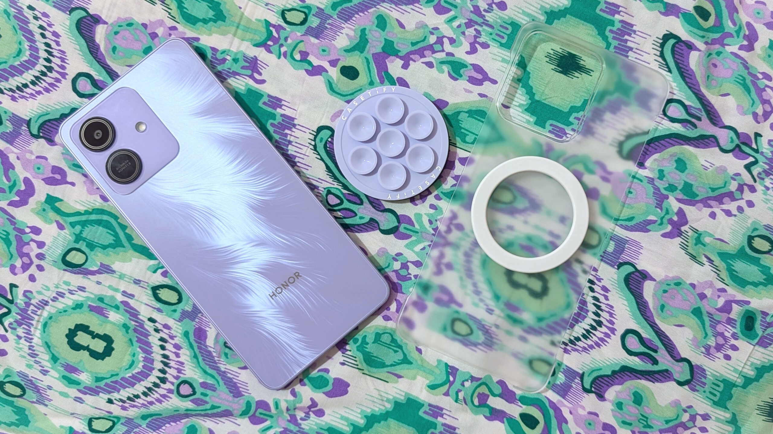 Honor Play 10 with clear case, magnetic ring sticker, and MagSafe accessories.