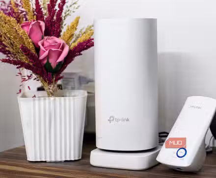 TP-Link Deco Mesh router next to Wi-Fi repeater