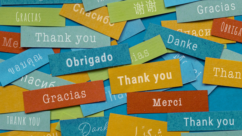 A pile of colorful tiles showing words of thanks in different languages