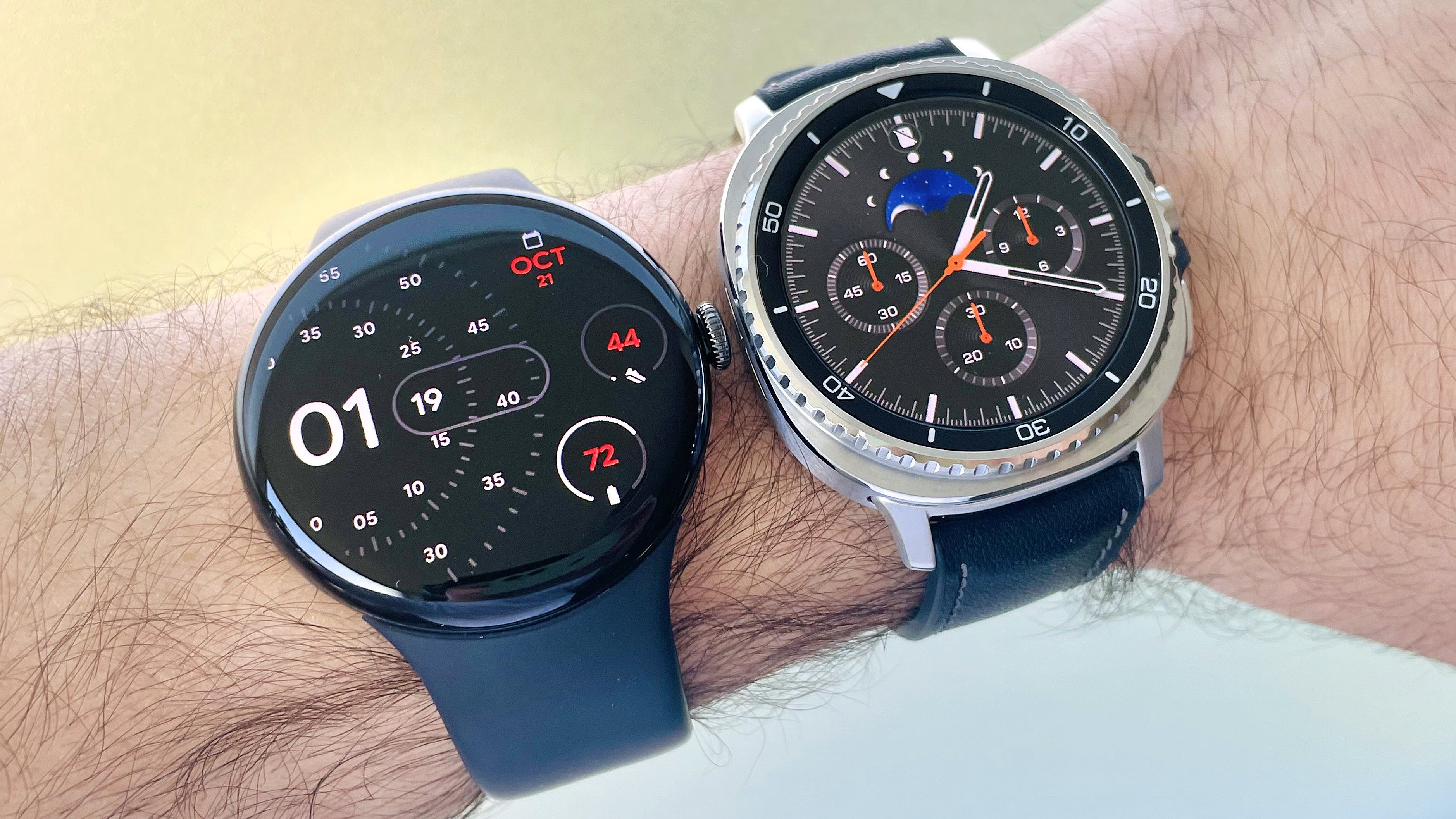 Soon the Google Pixel Watch 4 in the user's hand next to the Samsung Galaxy Watch 8 Classic.