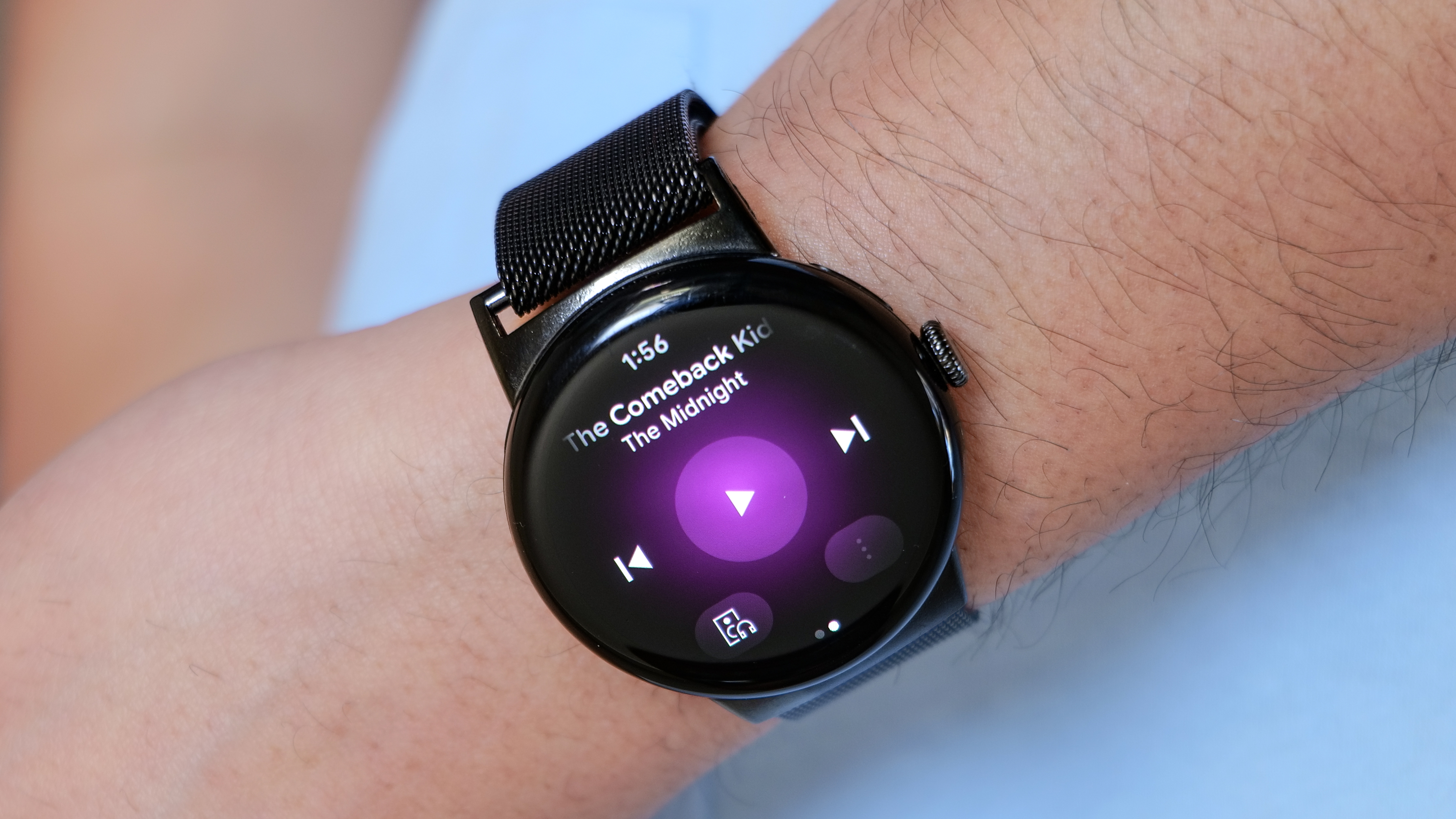 The Pixel Watch displays the YouTube Music app.