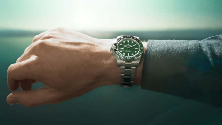 An analog wristwatch on a man's hand.