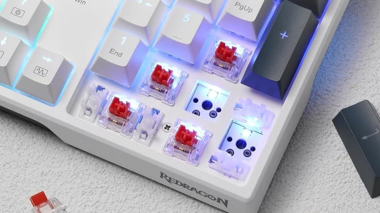 Redragon K668 RGB Gaming Keyboard with several keycaps and switches removed.