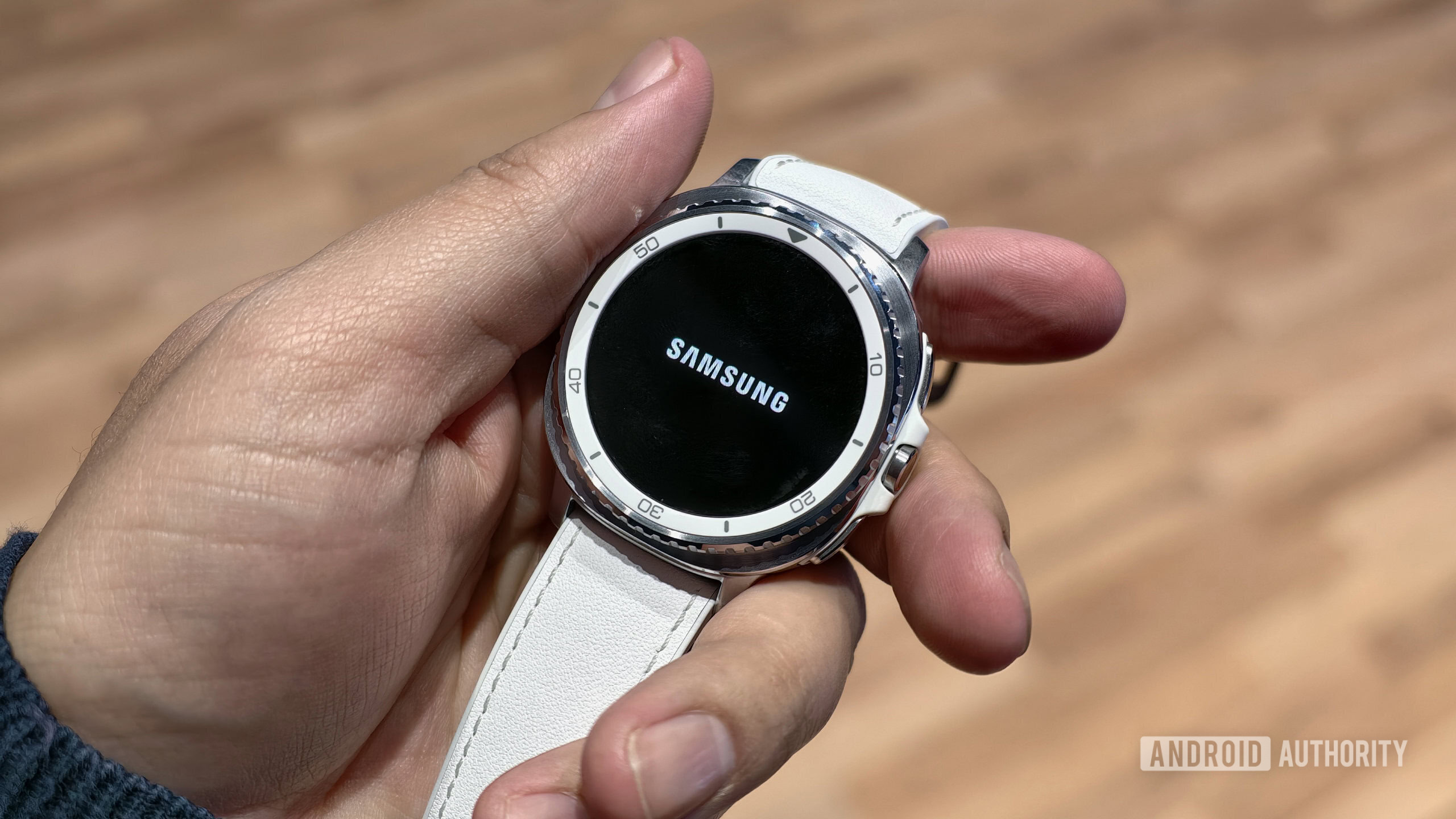 Samsung Galaxy Watch Classic on the wrist with the Samsung logo