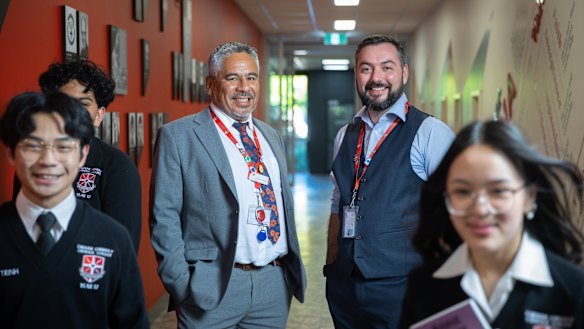 Caroline Chisholm Catholic College principal Napoleon Rodezno and assistant principal Tristan O'Brien with students.