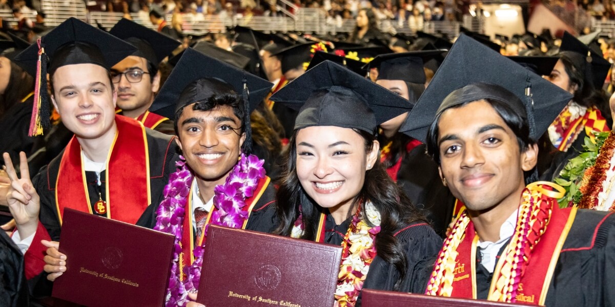 Undergrad students from 2025 standing with their degrees at commencement